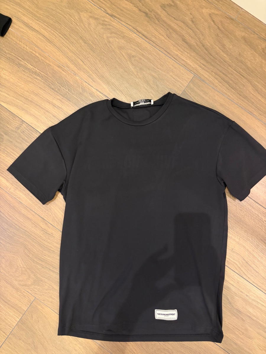 The Giving Movement t-shirt with writing on back. photo 2