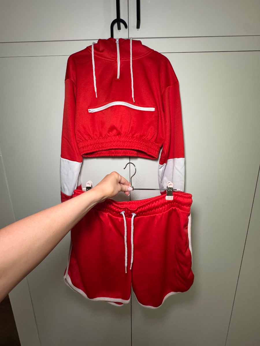 Pretty Little Thing Red cropped hoodie with matching shorts.