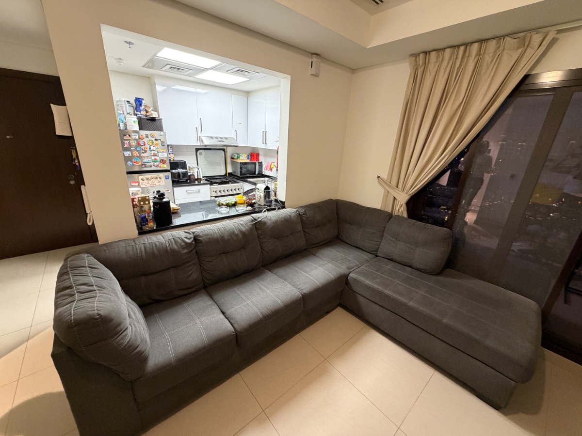L-shaped couch with separate storage unit.
