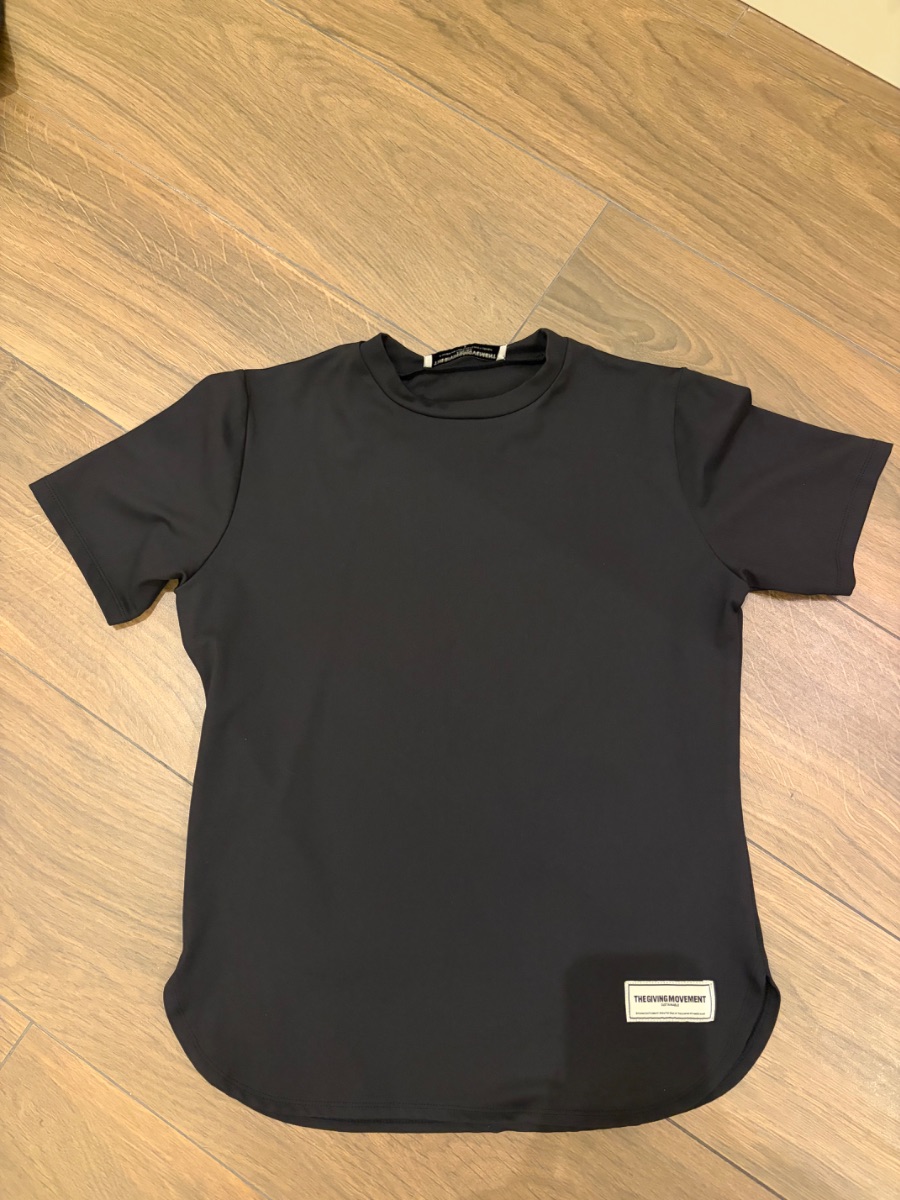 The Giving Movement black t-shirt.