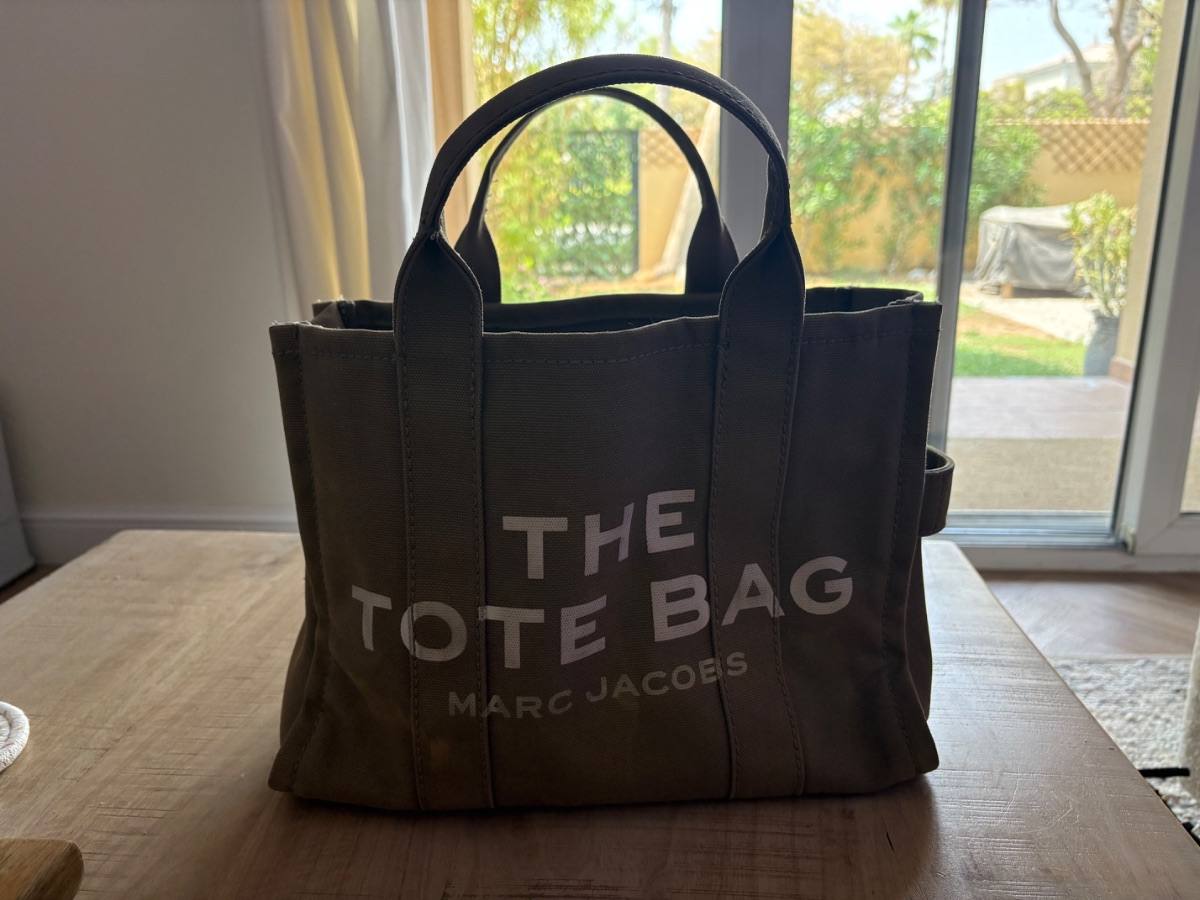A Marc Jacobs canvas tote bag listed on Loop