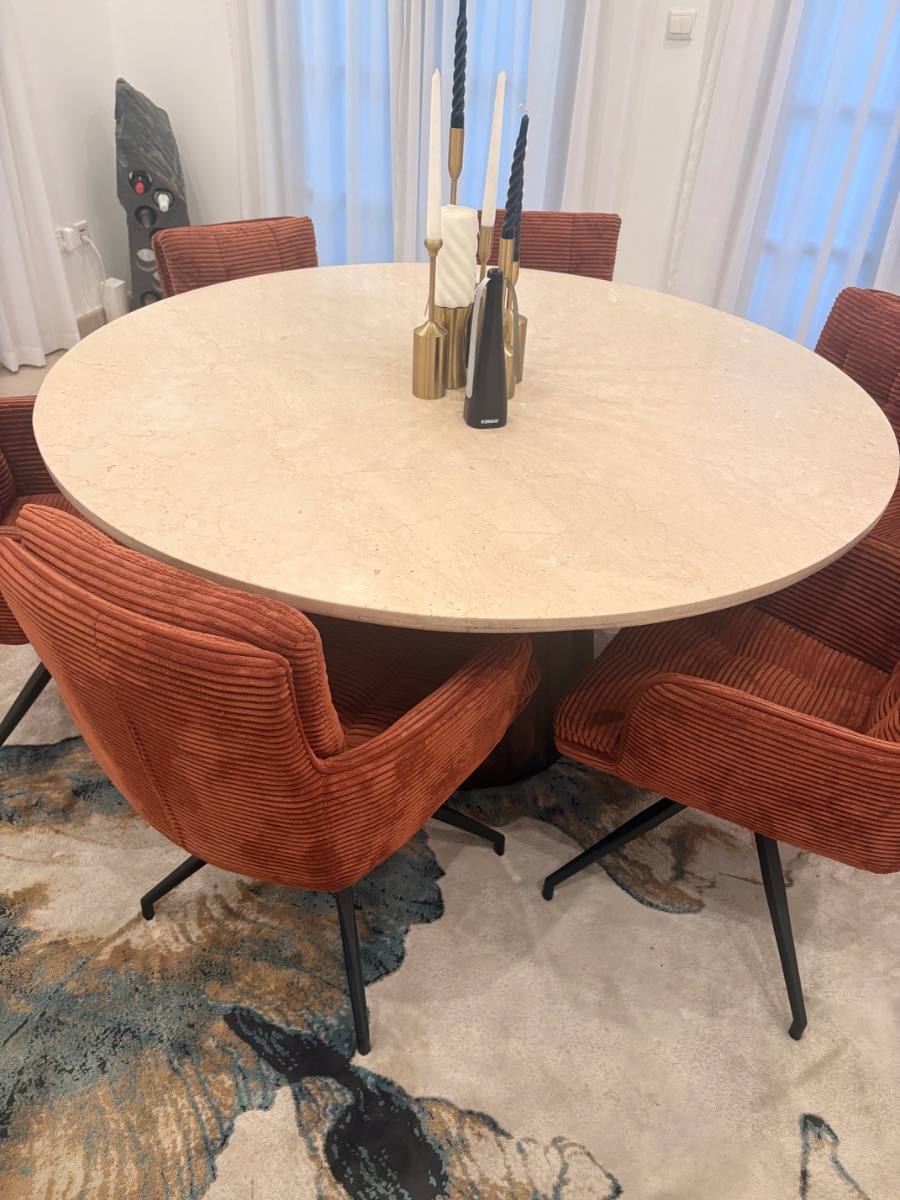 A round dining table with velvet chairs, listed on Loop