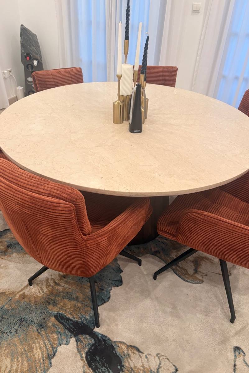 A round dining table with velvet chairs, listed on Loop